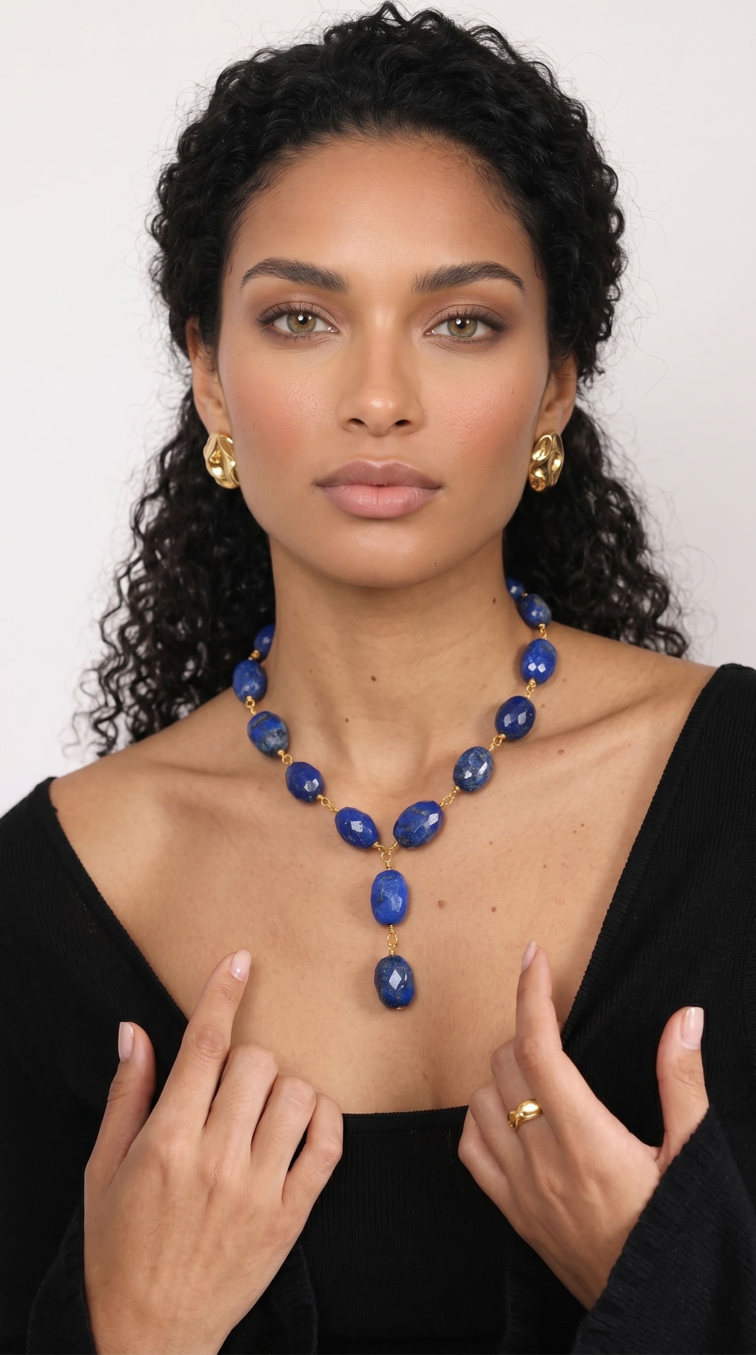 Curly haired woman wearing blue necklace